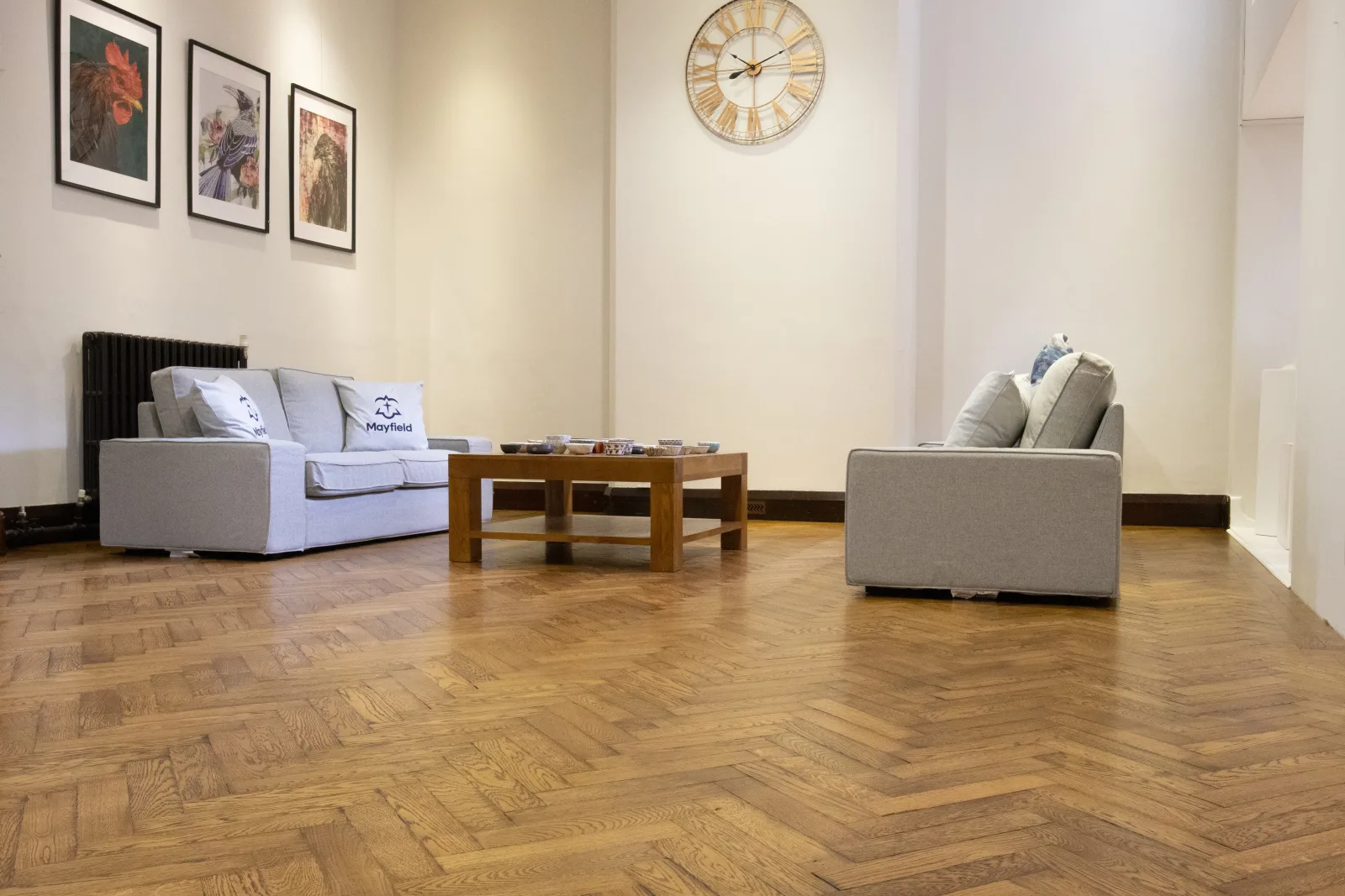 Restored herringbone floor in a light reception room